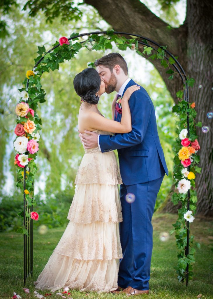 THE BROCKHOUSE VANCOUVER WEDDING FLORAL ARCH BHLDN ROSECLIFF GOWN SIMONS BLUE SUIT BUBBLES
