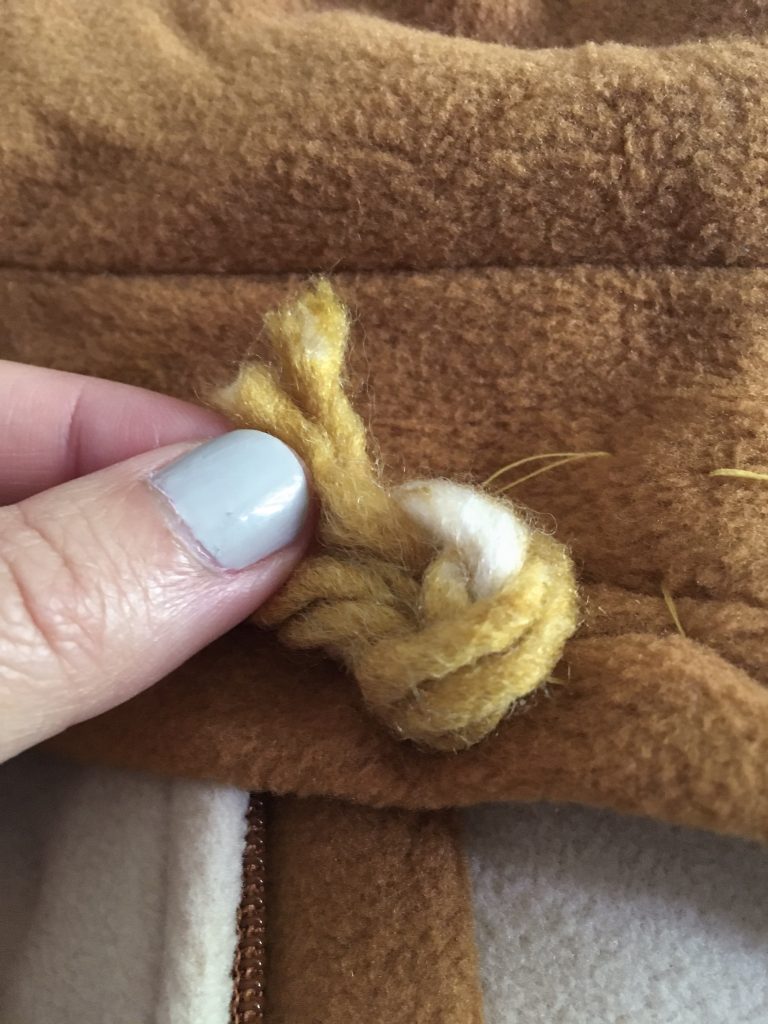 pull yarn ends through hold DIY baby lion Halloween costume Montreal lifestyle beauty fashion blog