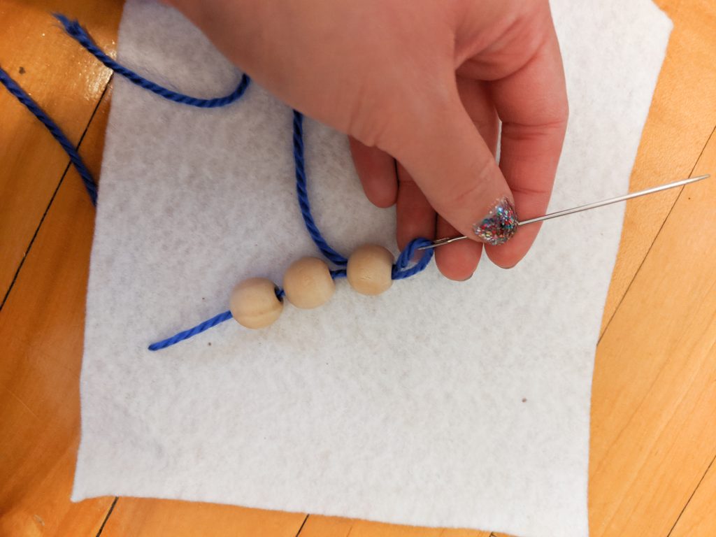 apply beads to one side and rethread needle DIY sensory blanket Montreal lifestyle fashion beauty blog