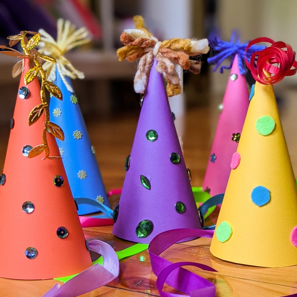 Cone Shaped Birthday Party Hat with Stripes and Ribbons Stock