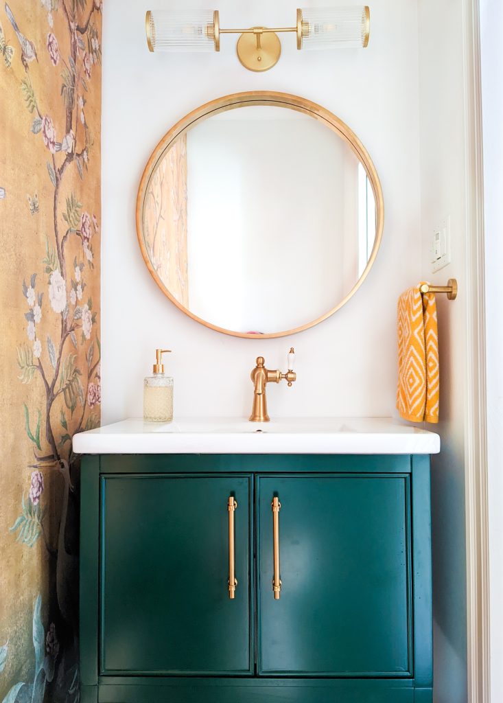 chinoiserie wallpaper circular mirror art deco light hunter green vanity gold accents bold powder room design Montreal lifestyle fashion beauty blog